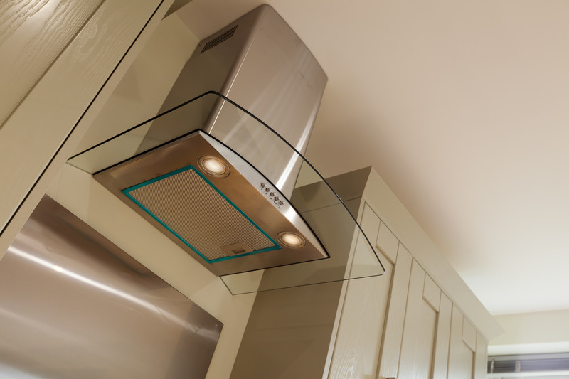 elevated kitchen extractor hood in between cupboards