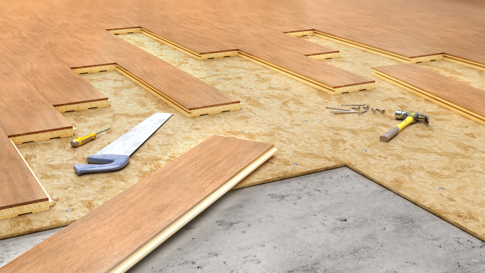 unfinished chipboard flooring with tools laying above