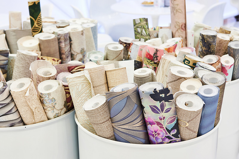 rolls of wallpaper in a white container