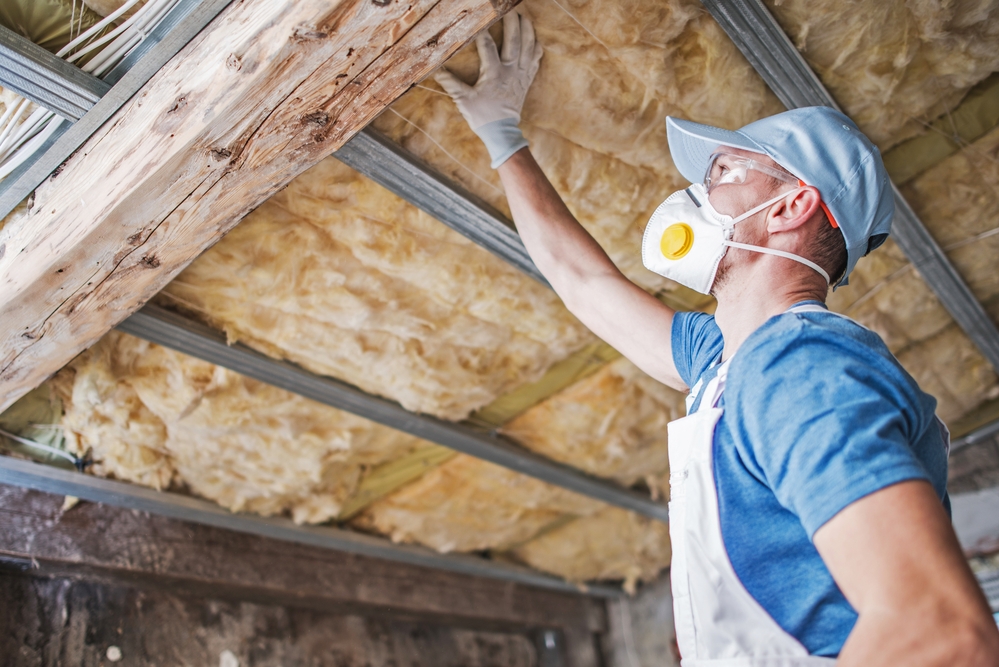 worker inspecting roof insulation